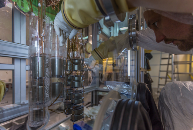 From Nature: “Working on the germanium detector array within the glove box which is located in the clean room on top of the liquid argon cryostat.” (Image: J. Suvorov, GERDA collaboration)